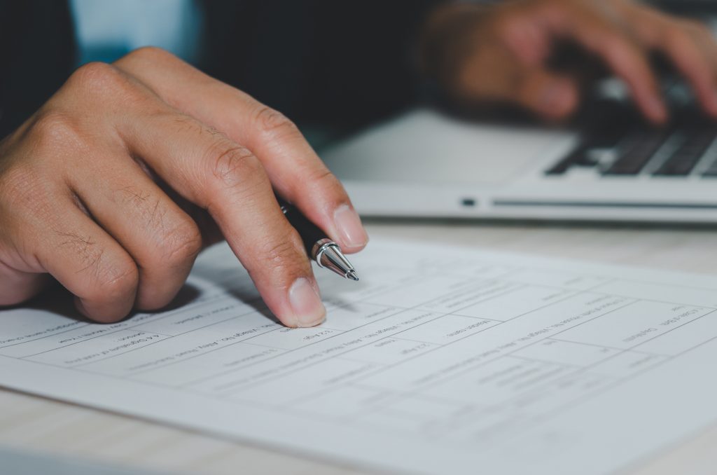 manager holds the pen and documents on the desk